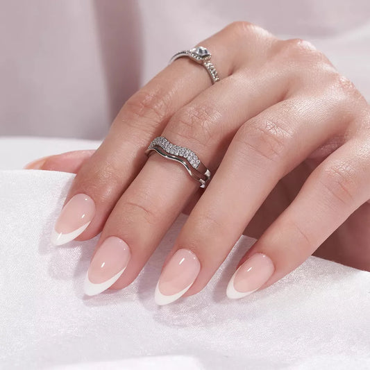 Hand wearing a silver ring with a diamond on a white background