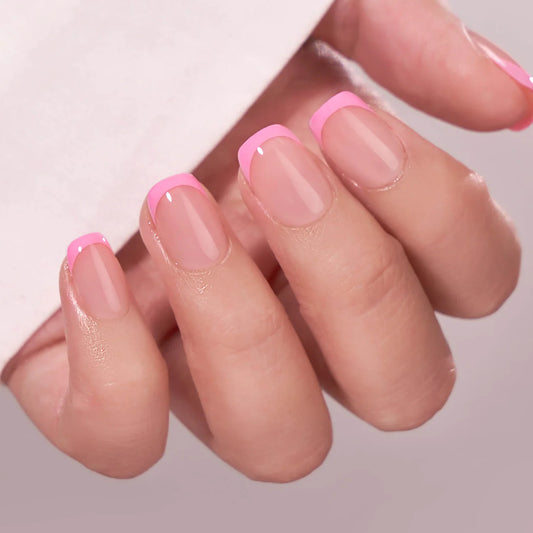 Close-up of a hand with pink nail polish on a neutral background