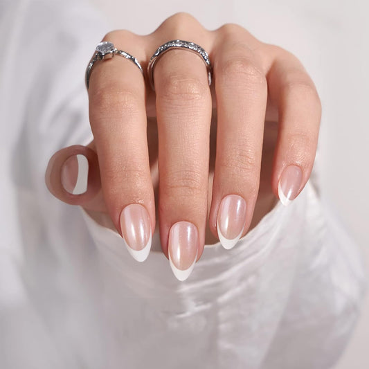 Hand with pink nail polish and silver rings on a white background